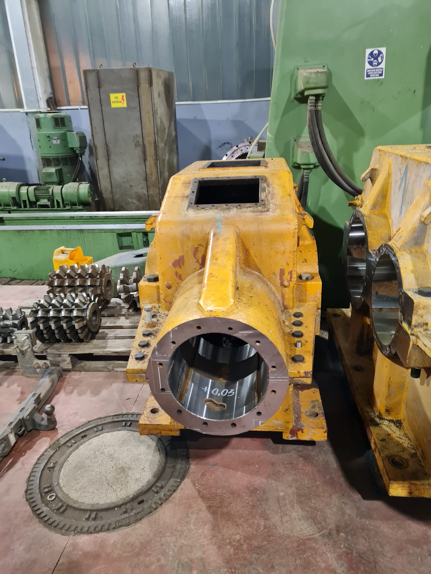 Yellow gearbox housing with a machined bearing seat marked +0.05
