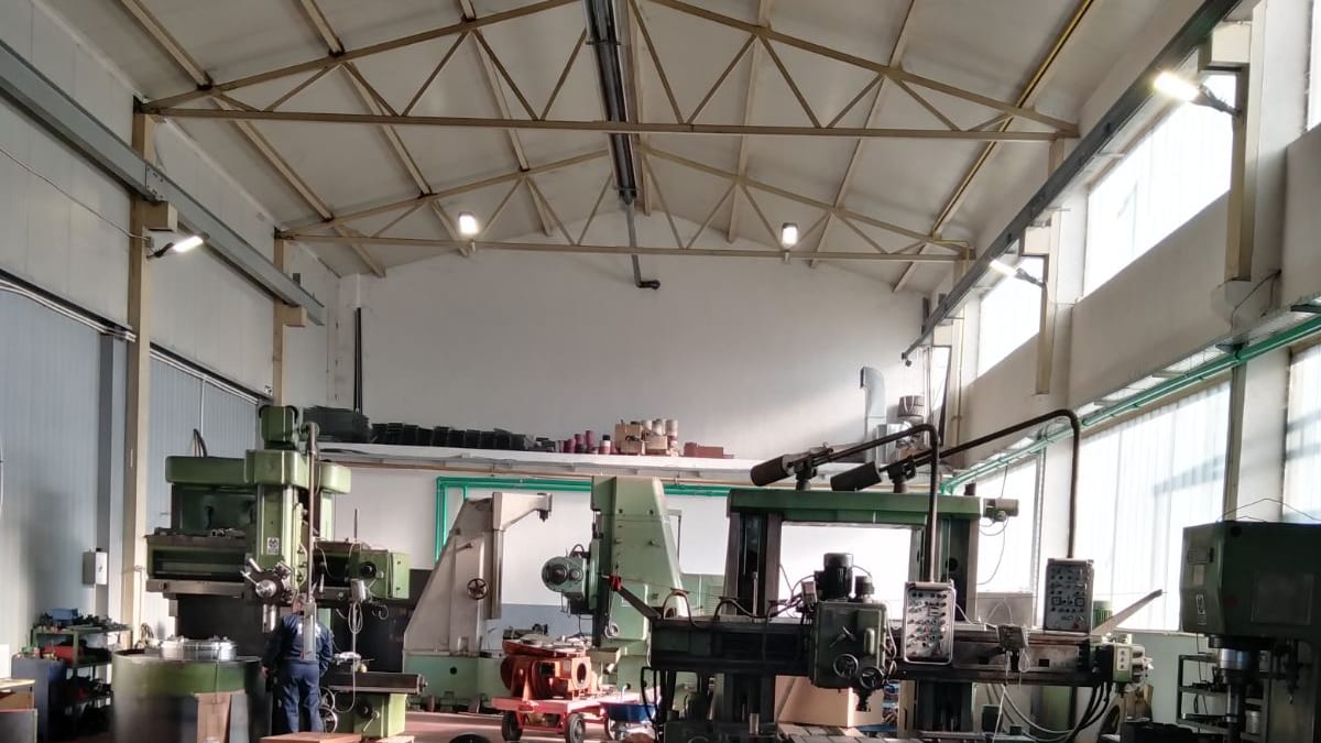Machine hall with machine tools, pallets of finished parts and rolls